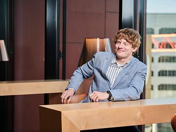 A man sitting on a table and smiles