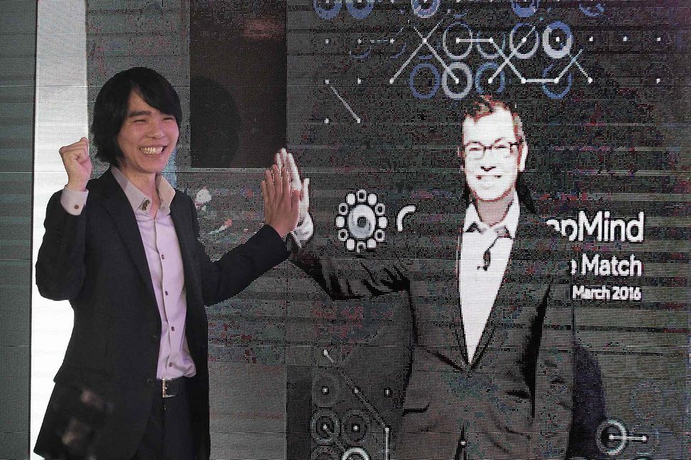 Lee Sedol gibt nach dem Match 2016 einem Bild von Demis Hassabis ein High-Five