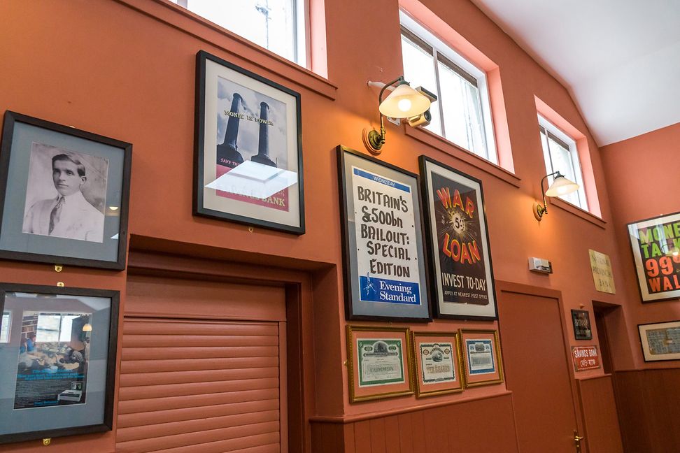 A wall with newspaper articles in the Library of Mistakes