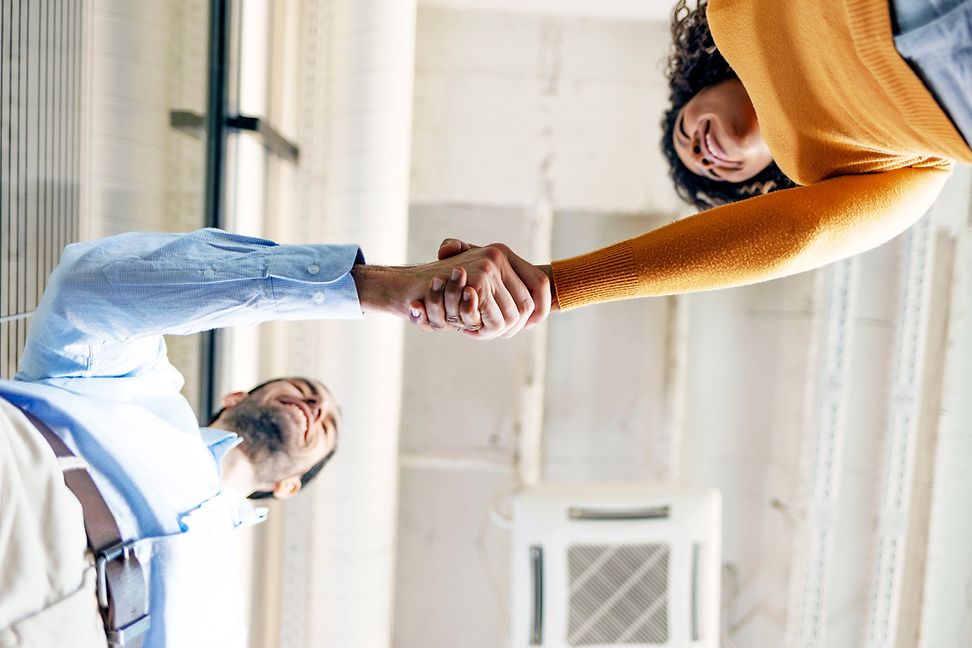 Woman and man shaking hands