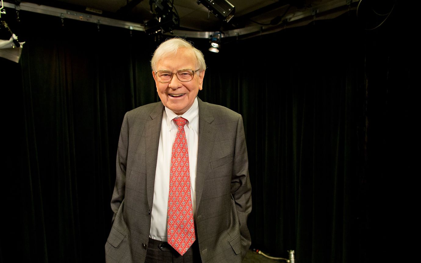 Warren Buffett in a suit and a red tie