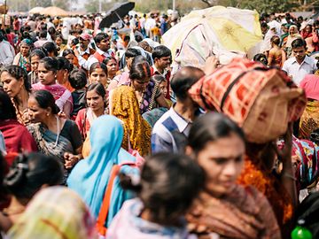 People crowded into a busy street in Delhi, India