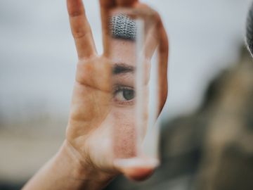 Woman looking into a mirror