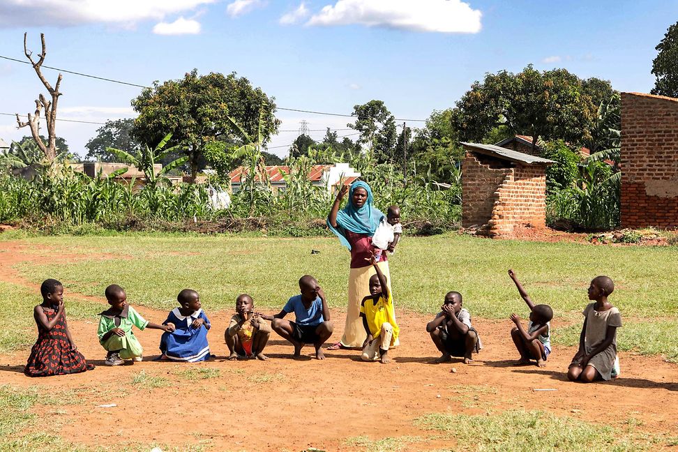 Children and volunteer waving