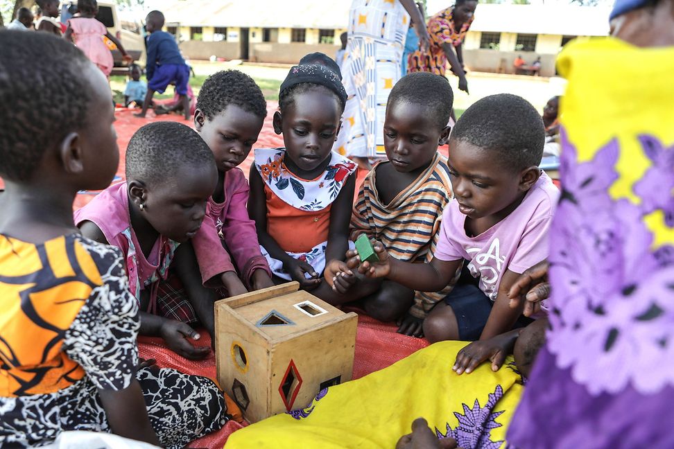 A group of small children playing with colourful toys