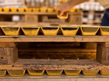 Stacked gold bars in a bank vault