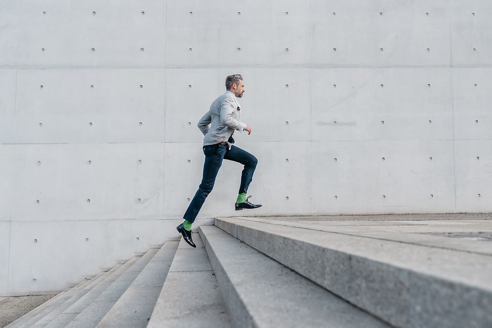 A man jogs up a flight of stairs