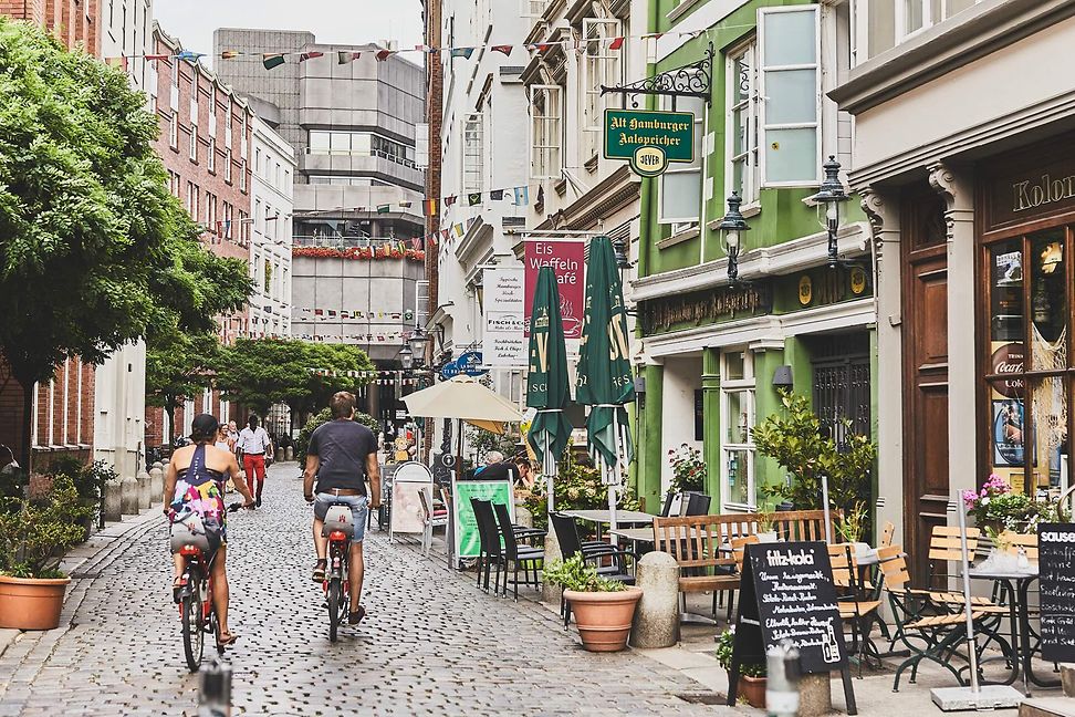 Two people on bicycles in the old town of Hamburg