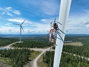 An Aerones robot is pulled up a wind turbine wheel