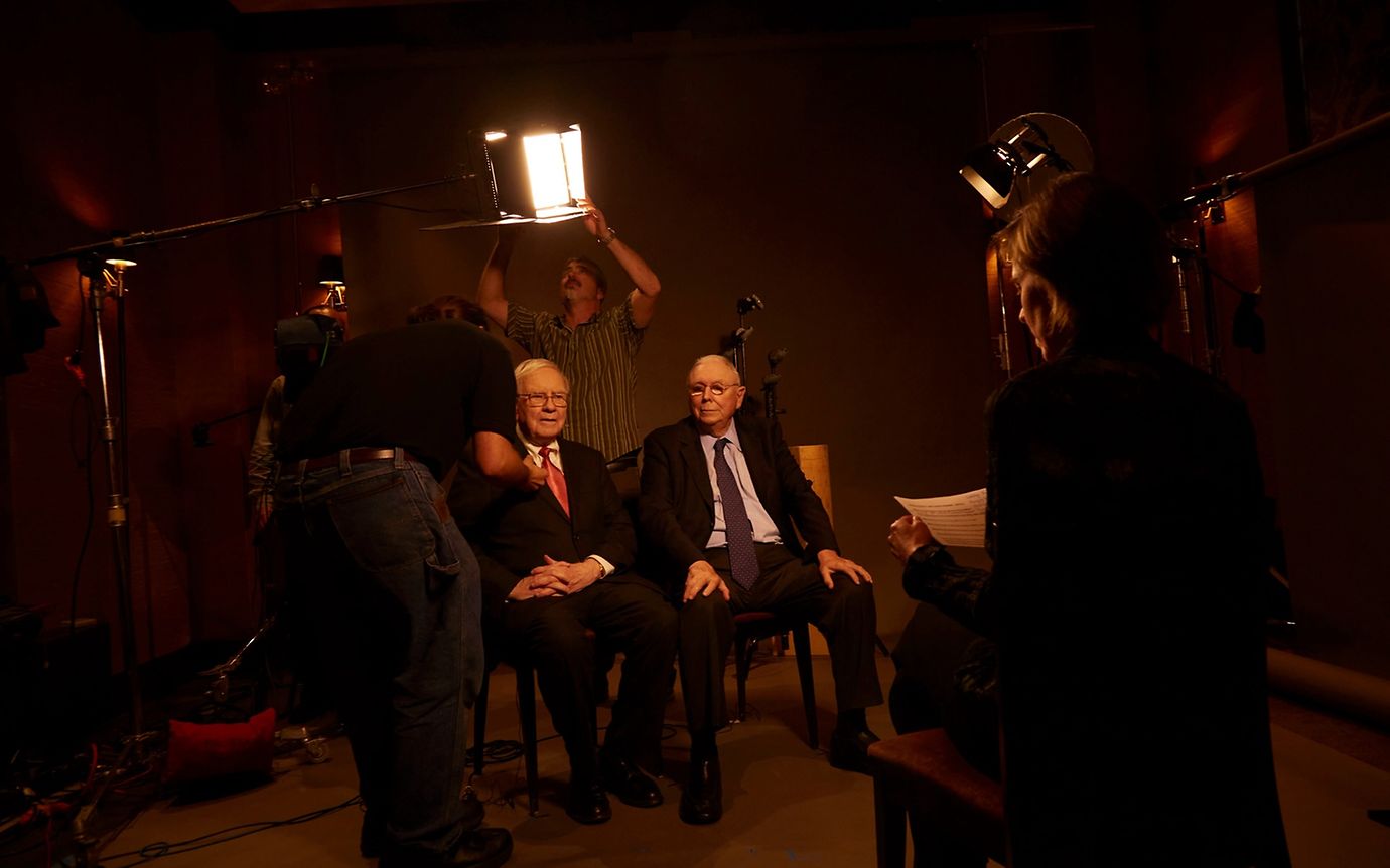 Two elderly gentlemen in suits and ties at a photo shoot