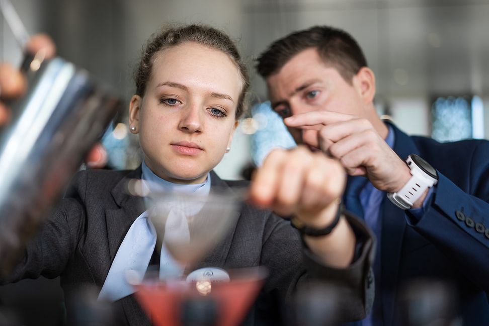 Two EHL students practice how to mix a cocktail 