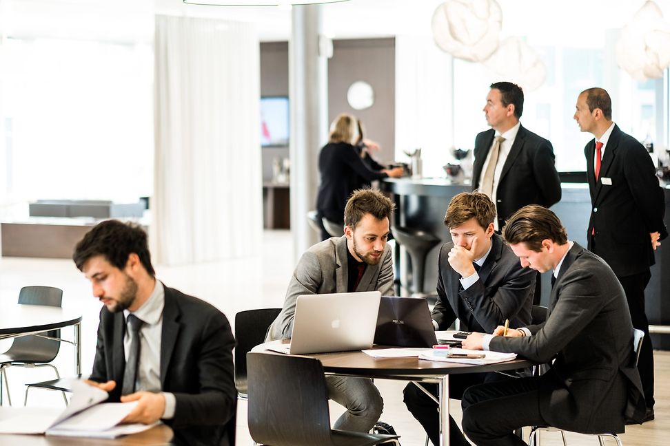 EHL students wearing suits, studying 