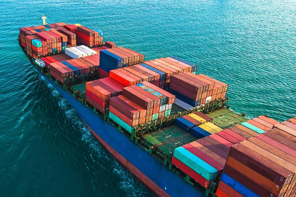 The deck of a fully loaded container ship at sea.