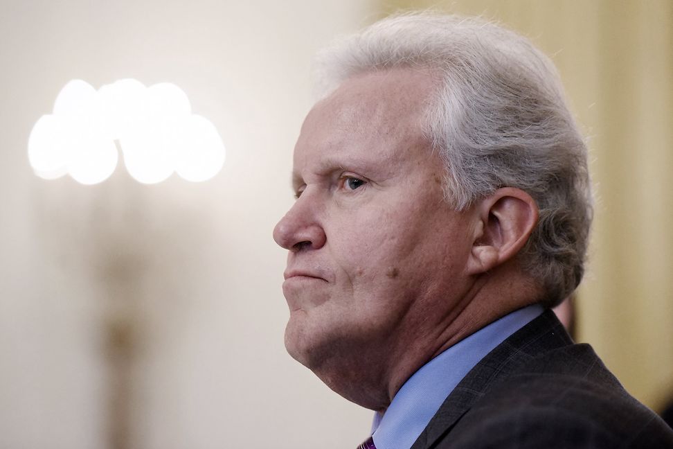 In profile, a man in a shirt and tie looks worried.