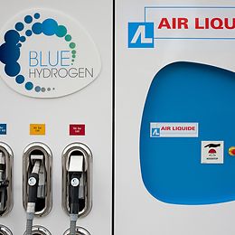 A petrol pump with three pumps and the words "Blue Hydrogen".