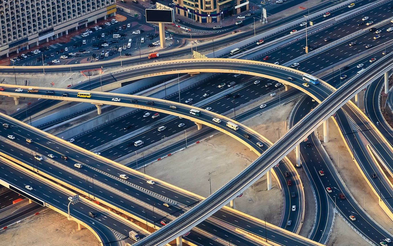 A bird's eye view of a major urban motorway with multiple entrances and exits.