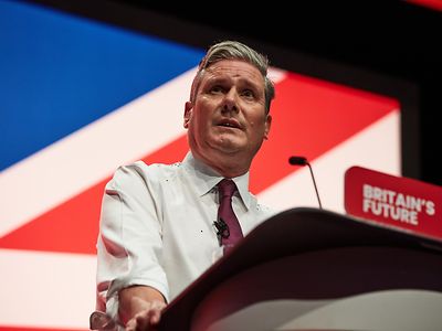 Keir Starmer stands at a podium to give a speech