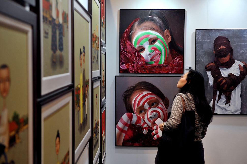 Woman in Hong Kong looking at art pieces