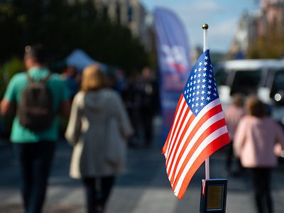 American flag set against blurred background of people