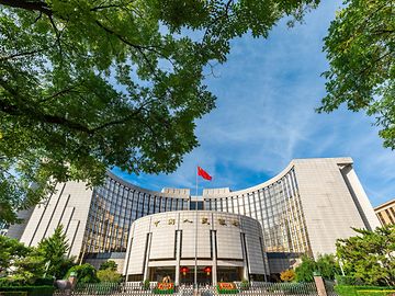 People's Bank of China is Beijing, surrounded by green trees.