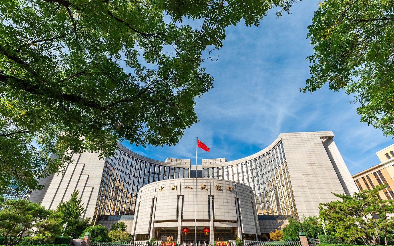 People's Bank of China is Beijing, surrounded by green trees.