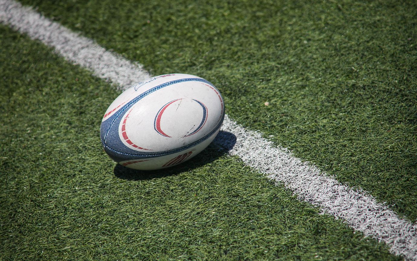 Rugby ball on lush green field