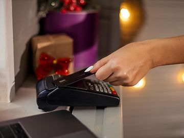 customer paying with card in christmas shop 