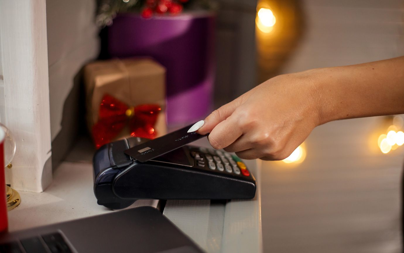 customer paying with card in christmas shop 